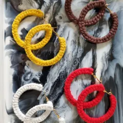 Add a pop of color and handmade charm to any outfit with my macrame hoop earrings. I craft these lightweight earrings in a variety of vibrant shades like yellow, white, red, and brown, so you can find the perfect pair to match your style.