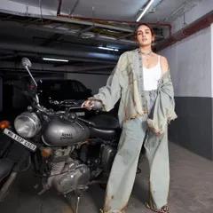 We created this raw, grunge moment with Huma Qureshi. It's all about the rust, denim, and attitude, with distressed layers from Huemn and silver accents to tie the wild energy together.