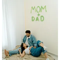 A sweet, relaxed moment after painting their big news on the wall. These candid shots are just as precious as the posed ones.