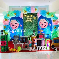 This Cocomelon setup features a grass wall with a neon sign, creating a nice contrast with the colorful characters and balloons.