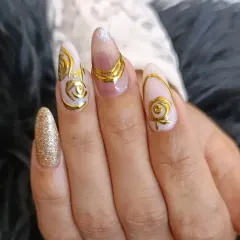 A closer look at the stunning 3D gold chrome roses on almond-shaped extensions, showcasing the intricate detail and metallic shine.