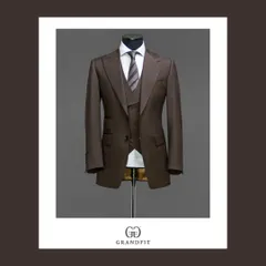 This bespoke three-piece suit in a rich brown fabric demonstrates true versatility. The addition of a matching waistcoat provides a layer of sophistication, making it an impeccable choice for business or formal occasions.