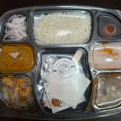 A neatly packed lunch thali with my brand sticker, ensuring hygiene and professional presentation for every order.