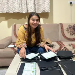 A candid shot of me with a completed bulk order of custom calendars. This project was a huge milestone for my small business.