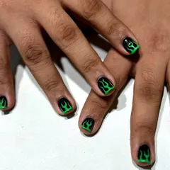 Nails have no gender. I created this edgy look with hand-painted neon green flames on a matte black base for a client who wanted to make a bold statement and break a few stereotypes.