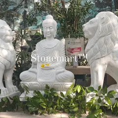 A view of the 4-foot Buddha and lions set amidst greenery. These large garden ornaments are crafted with love by our skilled murtikars using traditional hammer and chisel techniques.