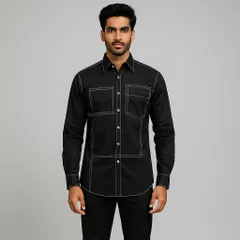 A modern take on a classic black shirt, this piece is defined by its bold geometric pattern created with thick, white contrast stitching. The design adds structure and a graphic element, elevating a simple shirt into a contemporary statement.