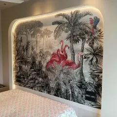 Another perspective of the flamingo and jungle mural, highlighting the placement of the colorful macaw and the detailed palm trees. This shows how our designs are perfectly scaled to fit unique architectural features like this curved wall.