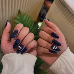 Another look at our popular 3D bow embellishment on a classic dark blue manicure.
