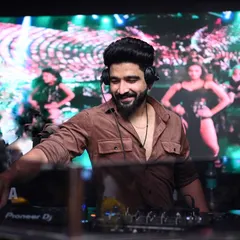 My sets are a full sensory ride. Here I am at Hex Mumbai, mixing tracks while the LED screen behind me shows dancers, creating a dynamic visual backdrop for the music.