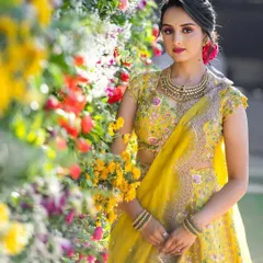 A perfect Haldi ceremony look. The bright yellow lehenga and floral jewellery are complemented by fresh, dewy makeup with a pop of pink on the lips.