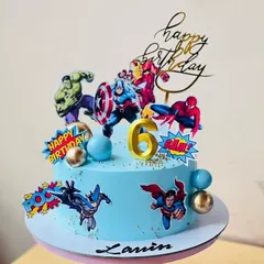 A vibrant superhero cake with The Hulk, Iron Man, and Spider-Man, perfect for a 6th birthday.