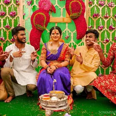 A playful portrait of the bride with her brothers or groomsmen, all pointing at her with big smiles.