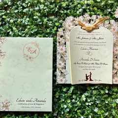 A beautiful Christian wedding invitation with a delicate laser-cut frame of daisies. The design is elegant and timeless, perfect for a church ceremony.
