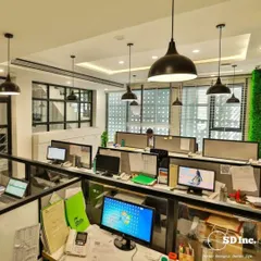 This is an open-plan workstation area designed for collaboration and efficiency. We used industrial-style pendant lighting and low-profile dividers to create a sense of community while still providing personal space for focused work.
