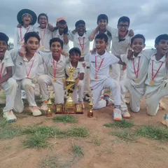 The victorious U-12 team posing with their championship trophy and medals. We believe in fostering a winning mentality and celebrating success as a team.