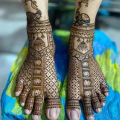 This unique design features a peacock on an elephant at the ankle, with lotus and geometric patterns covering the rest of the foot.