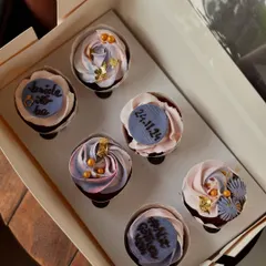 A beautiful set of cupcakes for a bridal shower. I used a mix of delicate frosting swirls, edible gold leaf, and custom fondant plaques with the wedding date to create an elegant look.