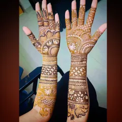 A clear, bright shot of the intricate elephant and peacock mehandi, showing the fine details in the artwork.
