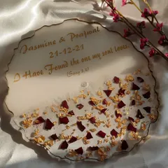 I love making personalized engagement platters. This one features the couple's names, their special date, and a meaningful quote, all surrounded by preserved rose petals and gold flakes for an elegant touch.