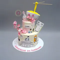A creative K-drama themed cake featuring an anti-gravity noodle bowl, cherry blossoms, and scenes from "Itaewon Class".
