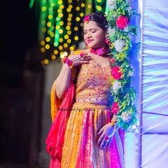Another shot from the Haldi ceremony, showing how the makeup and hairstyle complement the colorful floral decor and outfit.