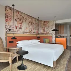 A custom wall mural in a suite at The Artiste, Kochi, inspired by the traditional Indian dance forms of Bharatnatyam and Teyyam, weaving local culture into the room's design.