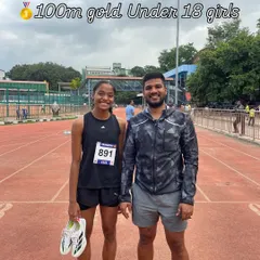 Gold in the 100m sprint. Our Under-18 girls' champion stands with her coach after a powerful performance at the State Level School Olympics.