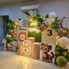A closer look at the details in our modern jungle theme, including the layered backdrop panels and the cute cartoon animal characters placed on pedestals.