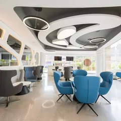 This wide shot of a modern commercial lounge for Architect Reza Kabul showcases my ability to capture complex designs and lighting. I focus on creating bright, inviting images that highlight the architectural details, like the unique ceiling structure and contemporary furniture arrangement.