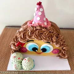 Another view of the cute, curly-haired half-cake.