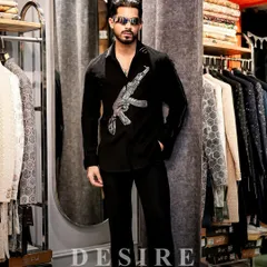 Dressed to make an impact. My custom black shirt with its bold firearm embroidery is seen here in my studio. It is a piece that combines a rebellious spirit with the precision of luxury tailoring.