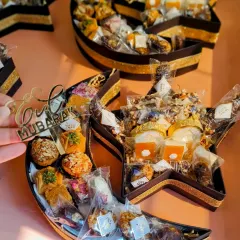 My 'Chand Taara' gourmet hamper is a favorite for Eid celebrations. The unique crescent and star shape is filled with traditional sweets like baklava and premium dates, making it a visually stunning and delicious gift.