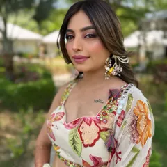 A portrait of the bride at her outdoor Haldi ceremony. The makeup is fresh and radiant, perfect for a sunny day celebration.
