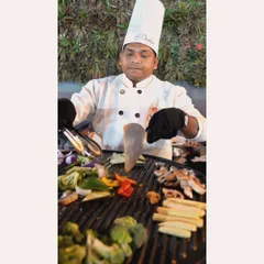 Our chef expertly grilling a colorful assortment of fresh vegetables for the 'Grillax Gourmet' dish. This live station offers a healthy yet incredibly flavorful option for guests.