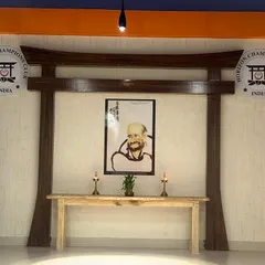 We welcome the spirit of Maha Guru Bodhidharma, the patriarch of Zen Buddhism and martial arts, into our dojo. This hand-painted photo connects us to the deep history of our art.