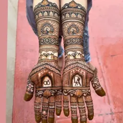 This engagement design features the couple's initials, 'A' and 'R', inside ornate windows on the palms, with peacock and swan motifs on the arms.