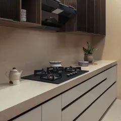 Even the smallest details contribute to the overall harmony. A minimalist kettle and a small plant on the clean countertop against a neutral backsplash create a sense of calm and order.