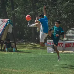 An incredible display of acrobatics as a player executes a flying kick during a heated corporate match. Our grounds are where professionals unleash their competitive side.