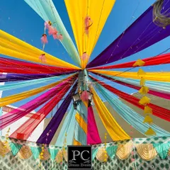 Looking up at the vibrant tent decor for the Mehndi function. I used multi-colored drapes radiating from the center to create a festive canopy for the celebration.