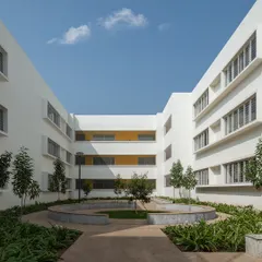 This internal courtyard at Vidyashilp Academy is a perfect example of a protected, green oasis. It acts as a light well, drawing daylight and air into the heart of the campus, while the circular seating and native planting create a peaceful retreat for students.