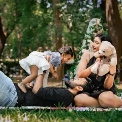 An outdoor family session in one of Bangalore's lovely parks. We use natural light to create vibrant, candid portraits that feel spontaneous and joyful, just like this moment of a father playing with his child.
