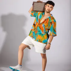 A vibrant, tropical-themed shoot for a men's summer collection. I paired a colorful printed shirt with white shorts and casual accessories like headphones and a speaker to create a fun, youthful, and energetic vibe.