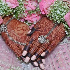 This is the result I live for. A gorgeous, deep henna stain on my bride's hands, perfectly complemented by her floral jewelry. I use only organic henna to ensure you get this rich, beautiful color for your special day.