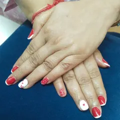 A fun and playful set featuring red and white gel polish. I created a mix of designs, including polka dots, tiny hearts, and a larger heart on the accent nail. This kind of custom mix-and-match art is great for any fun occasion.