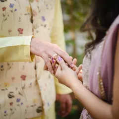 The ring exchange. A close up on this significant moment, showing the bride placing the engagement ring on the groom's finger. A simple, powerful symbol of commitment.