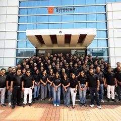 Our entire team standing together in front of our new office. This building is built on the ambition, teamwork, and drive that defines the Syrotech family.