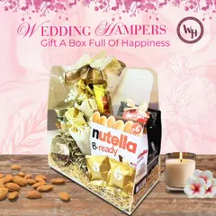 A "Box Full of Happiness" is what I aim for with my wedding hampers. This clear acrylic box is filled with gourmet treats like Nutella B-ready and dry fruits, making it a delightful and indulgent gift for couples or guests.