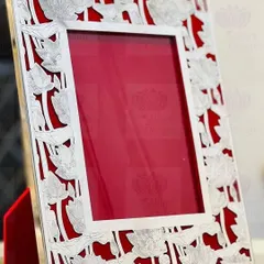 The lotus is a symbol of purity and beauty, and I love using it in my designs. This elegant silver frame features a delicate lotus flower cutout pattern against a rich red velvet background.