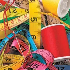 Work in progress. A collection of measuring tapes and colorful threads, the essential tools of my trade, ready to bring new designs to life.